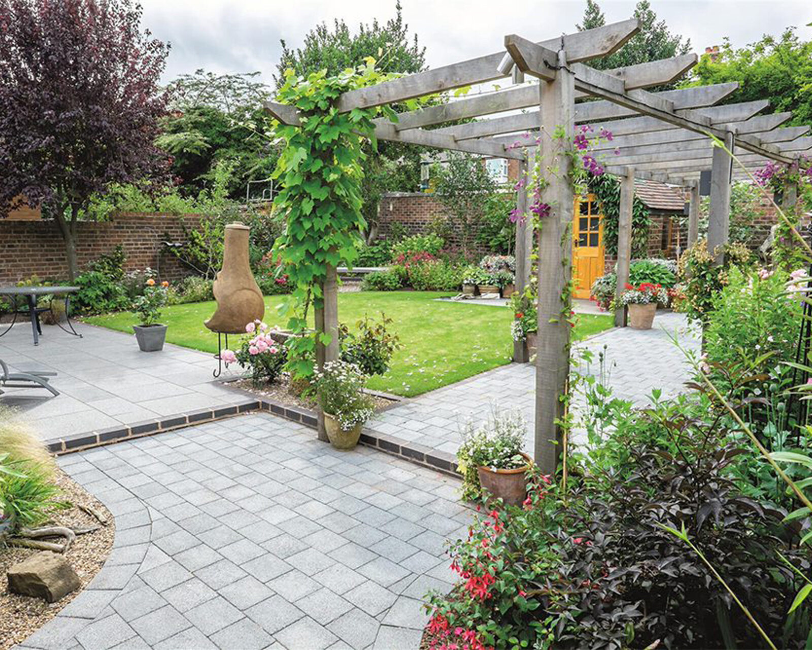 Block paving pathway through a residential garden